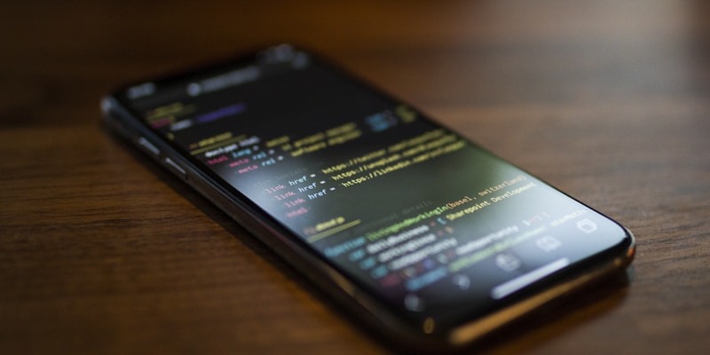 Developer coding a native mobile application with multiple screens and device testing